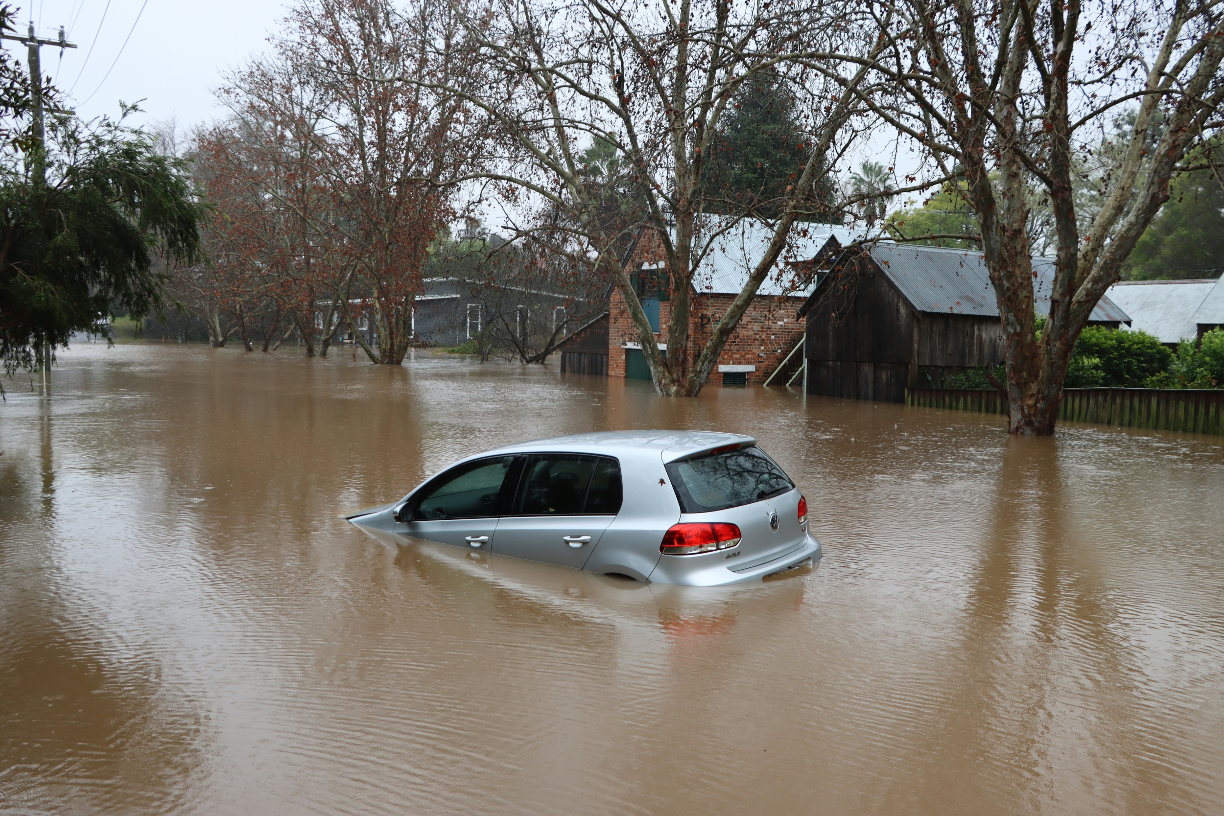 Car Floating through a Flooded Street