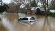 Car Floating through a Flooded Street