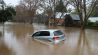 Car Floating through a Flooded Street