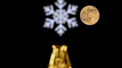 Wolf moon behind a Christmas and New Year's decoration in Moscow on January 7, 2023